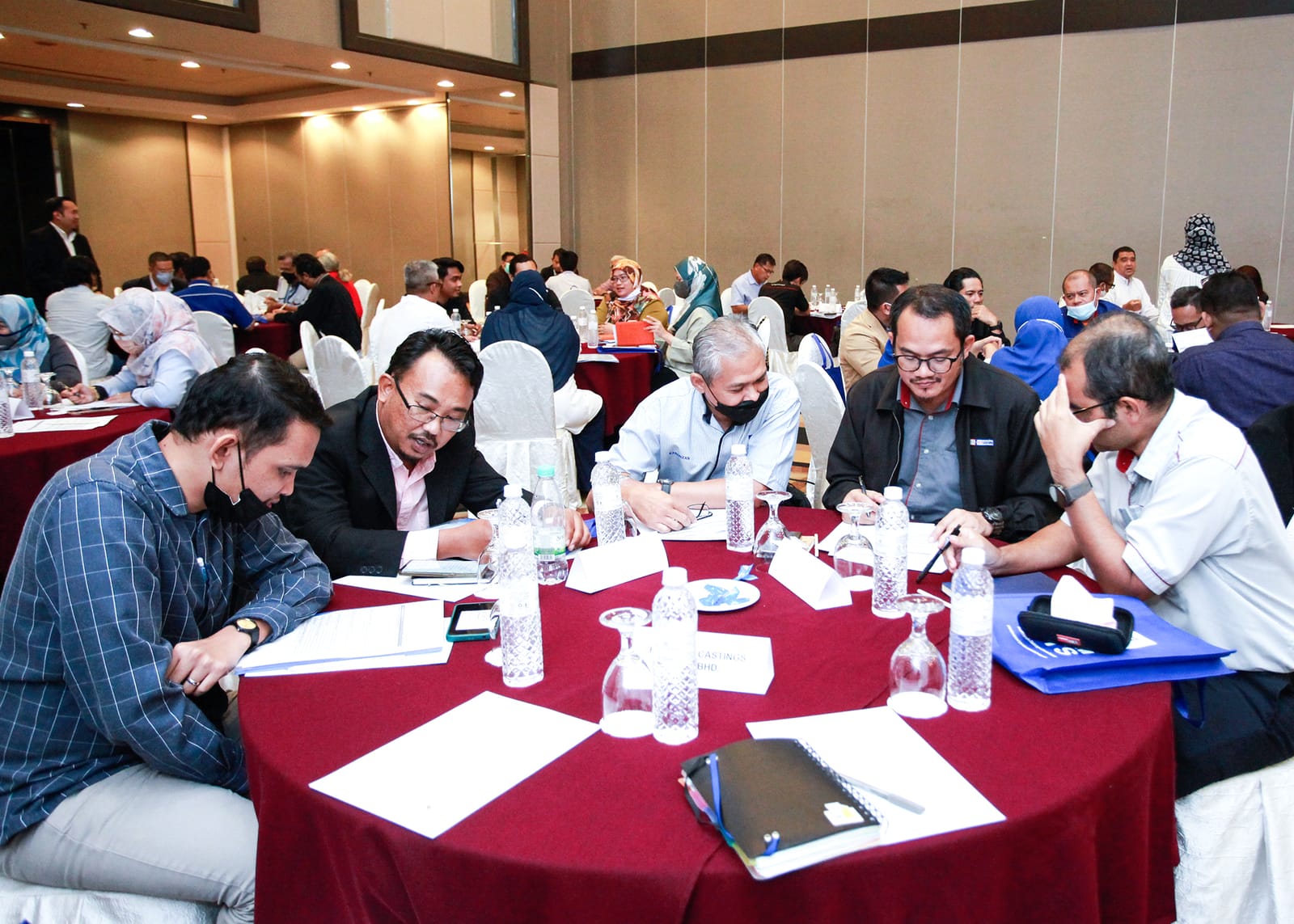 Participants in discussion at round tables during the workshop