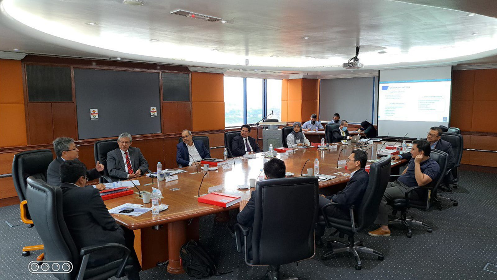 Steering committee members around the boardroom table