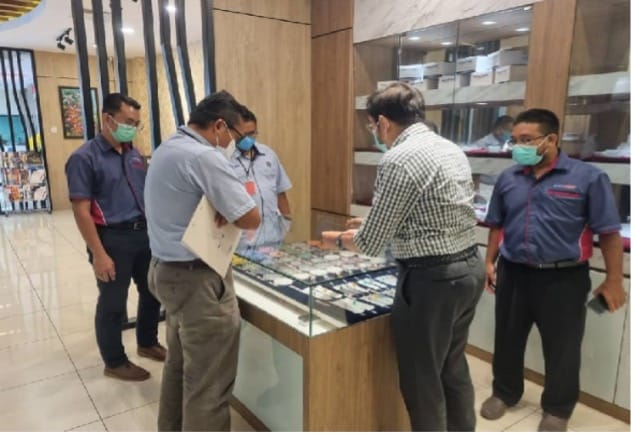 The assessment team viewing a display of the company's products